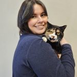 girl holding scared cat