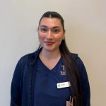 Female with long brown hair pulled back in a pony tail